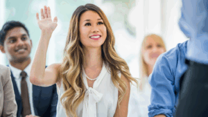 Woman asking questions in room of colleagues to define employer brand